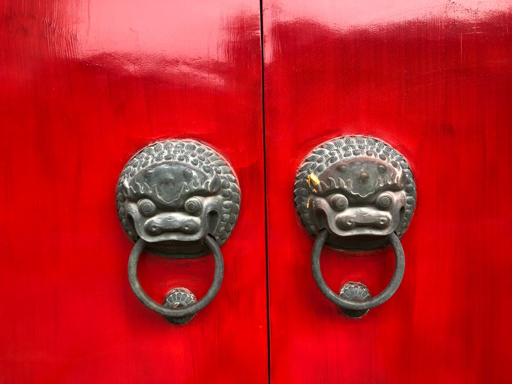 Red door, photo by Kayla Kozlowski on Unsplash